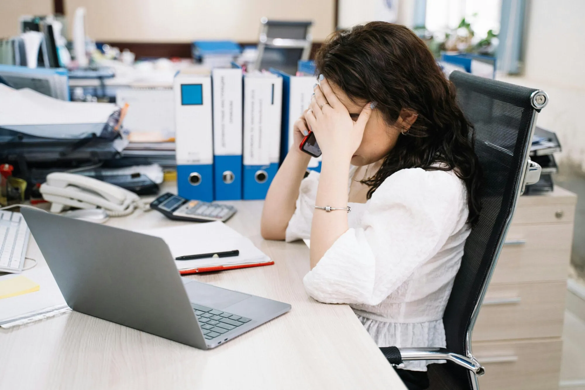 Worker on the receiving end of a tough phone call.
